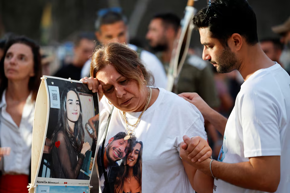 Woman sheds tears during the commemoration of people killed and kidnapped by Hamas on October 7, 2023/Reuters/Amir Cohen